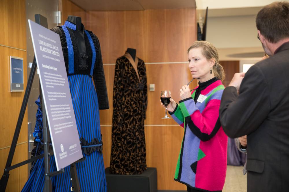 Guests looking at costumes on display.